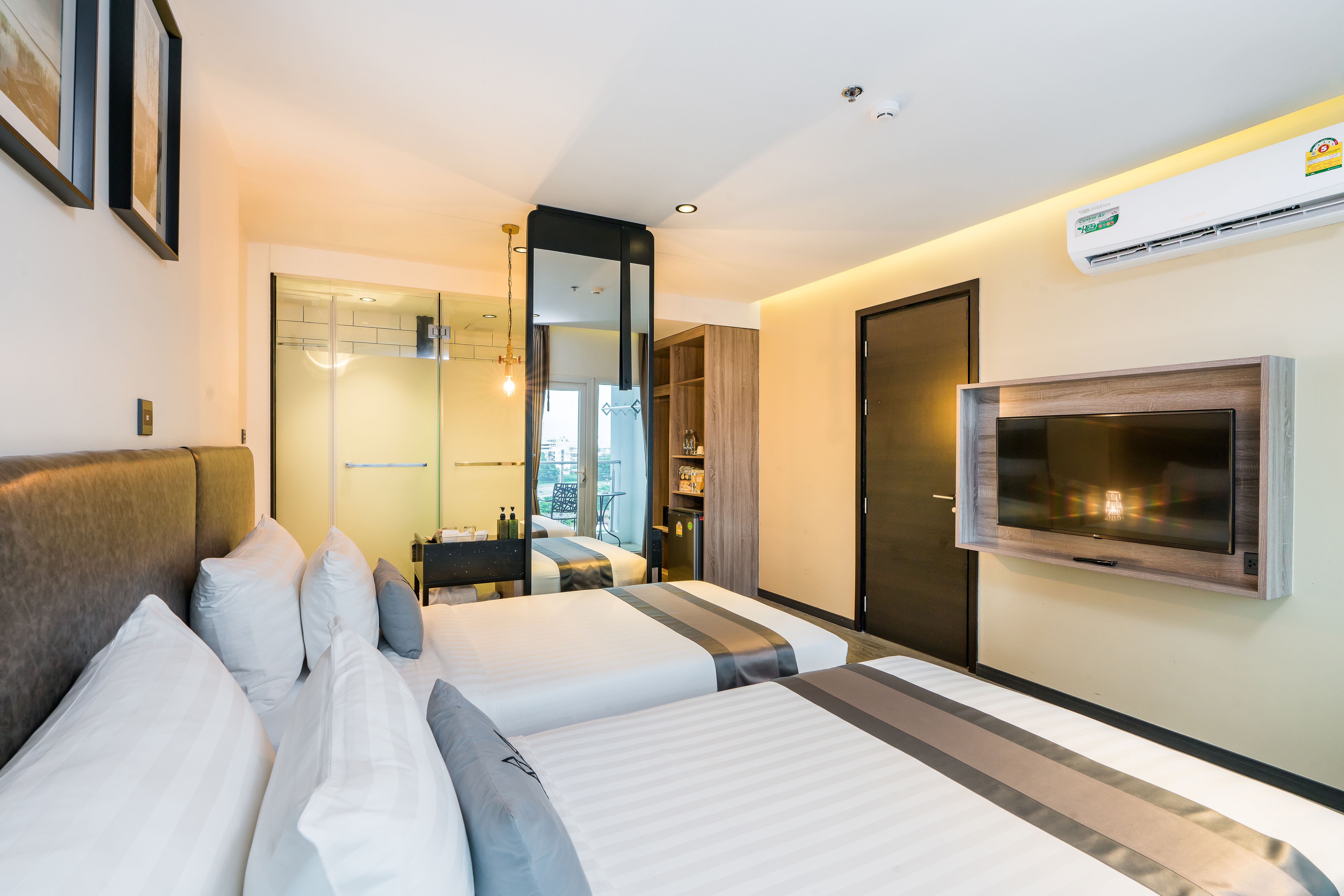 Superior Room interior at T Pattaya Hotel — modern industrial-loft design with king bed